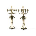 A pair of gilt and patinated bronze five light candelabra in late Louis XVI taste