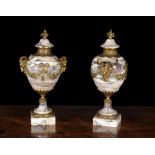 A pair of Breche Violette and gilt metal mounted ornamental urns in Louis XVI style