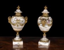 A pair of Breche Violette and gilt metal mounted ornamental urns in Louis XVI style