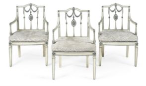 A set of three painted and parcel gilt open armchairs, circa 1790 and later re-painted