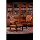 A pair of William IV mahogany and leather upholstered armchairs