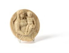 A North Italian sculpted white marble tondo of the Virgin and Child enthroned