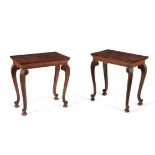 A matched pair of walnut and carved pine side tables