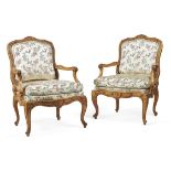 A pair of Louis XV carved beech and upholstered fauteuil