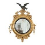 A George III giltwood convex girandole wall mirror