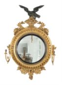 A George III giltwood convex girandole wall mirror