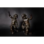 After Ferdinando Tacca, a pair of Italian patinated bronze models of musician putti