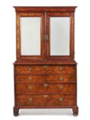 A George I figured walnut and feather banded secretaire cabinet