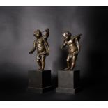 A pair of French patinated bronze models of putti emblematic of Astronomy