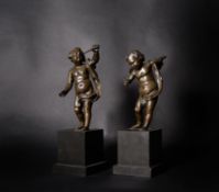 A pair of French patinated bronze models of putti emblematic of Astronomy