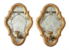 A pair of Italian carved giltwood and etched glass girandole wall mirrors