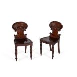 A pair of George IV mahogany hall chairs