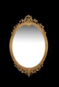 A Victorian carved giltwood and composition oval wall mirror by J & W Vokins