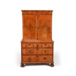 A Queen Anne walnut and feather banded cabinet on chest