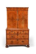 A Queen Anne walnut and feather banded cabinet on chest