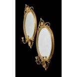 A pair of giltwood girandole wall mirrors