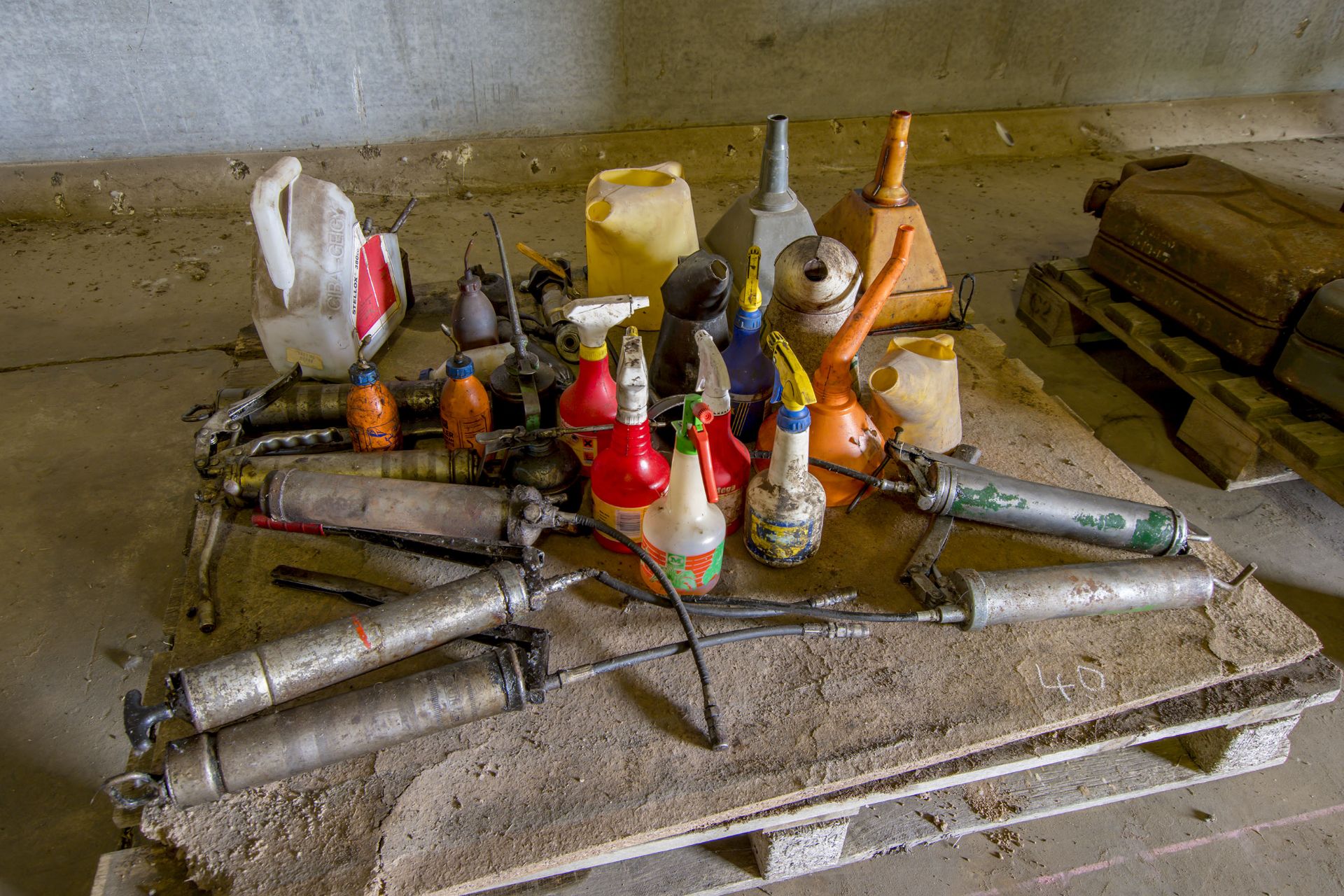 Pallet of assorted grease guns, funnels and oil cans.