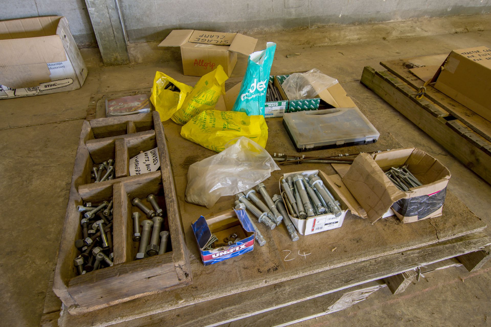 Pallet of used and unused assorted nuts and bolts.