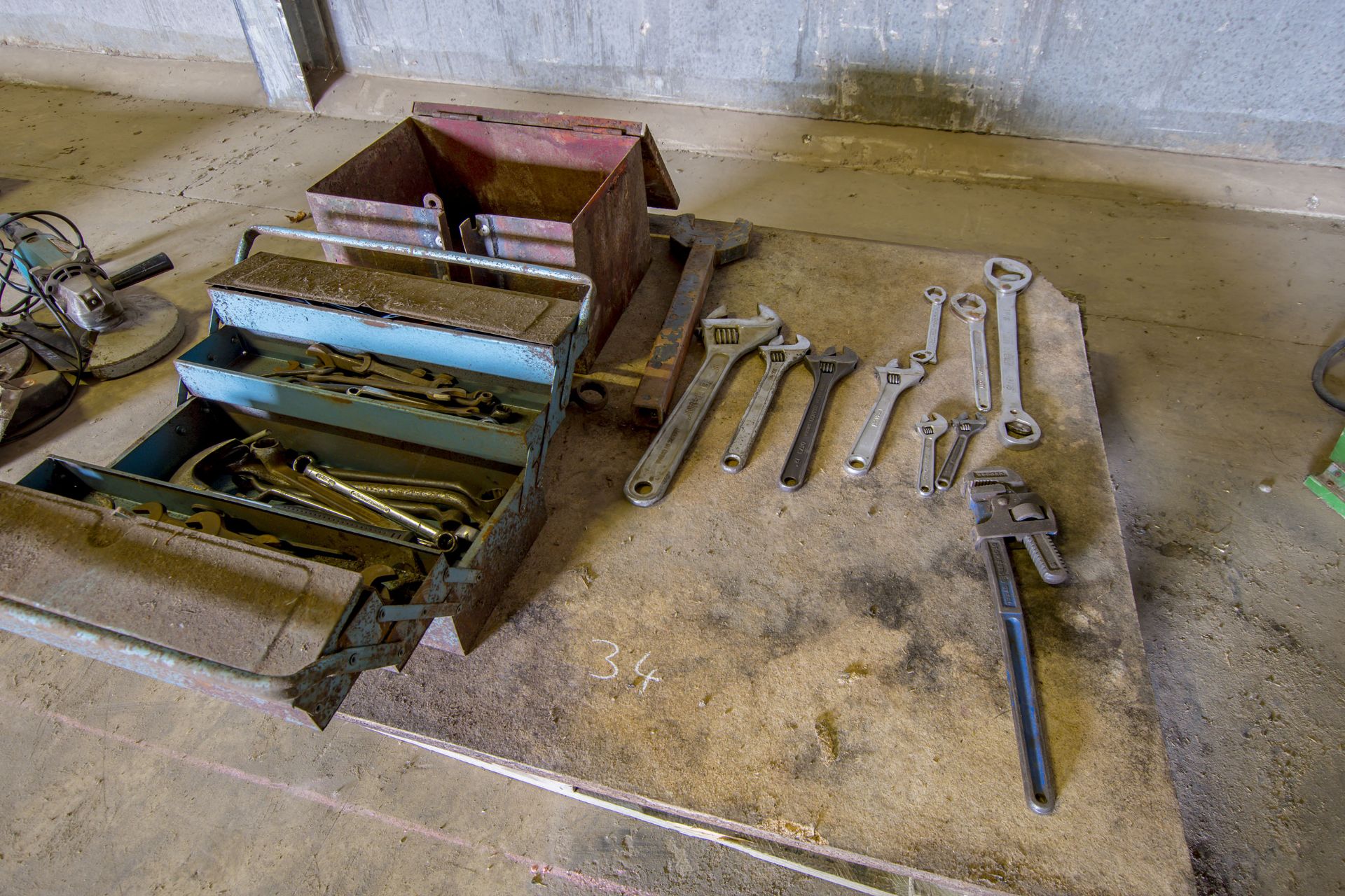 Pallet of assorted adjustable spanners, metal tool box and contents.