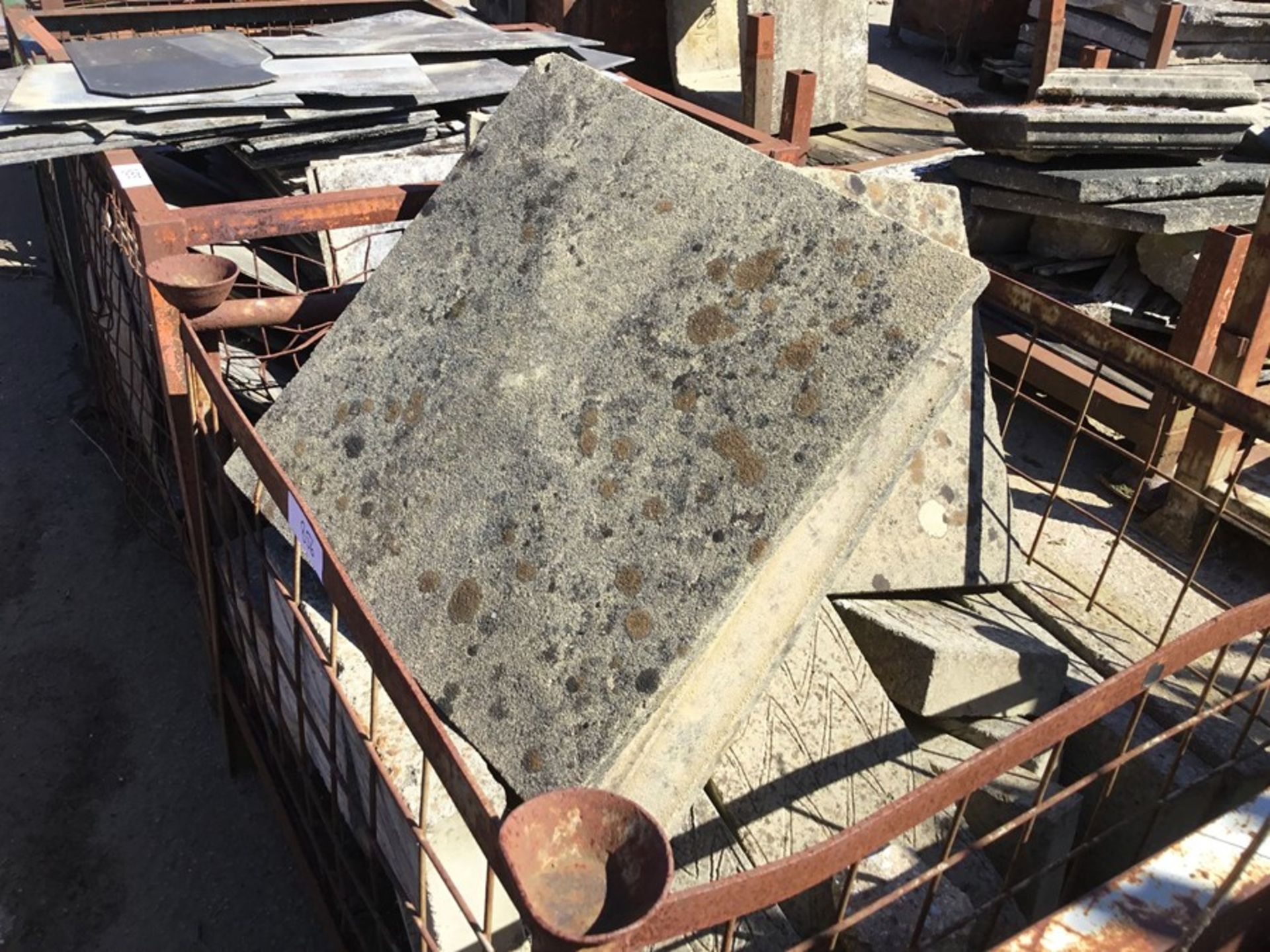 Cage containing Misc. . Concrete blocks and sand stone plinths