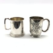 Plain silver Christening mug with angular handle London 1977 and another with embossed decoration