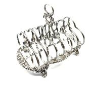 George IV silver six division toast rack with loop handle and shell moulded border on short shaped