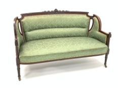 Late Victorian walnut two seat sofa upholstered in green damask fabric,