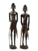 Pair of African tribal art carved hardwood standing male and female figures with bead necklaces