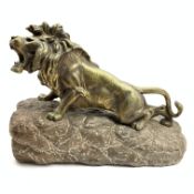 Style of Joseph D'Aste - 20th Century cast gilt bronze figure of a lion on a rocky outcrop L39cm x