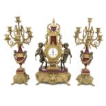 20th century Empire style brass clock garniture, with red enamel detail,