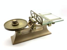 Set of platform scales with glass table and three brass weights,
