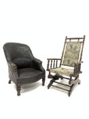 19th century tub shaped armchair upholstered in black leather, raised on turned mahogany supports,