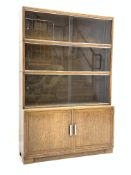 Early 20th century oak Minty stacking bookcase on cupboard,