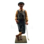 Modern resin model of a vintage golfer,