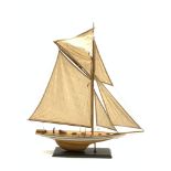 Wooden model Yacht on an oblong stand,