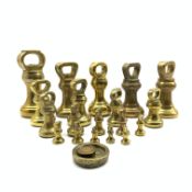 Collection of nineteen brass bell weights 1oz - 7lbs with various stamps and two other weights