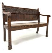 19th century oak hall settle, with relief carved floral frieze above panelled back,