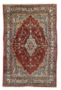 Large central Asian ground rug, lozenge medallion on red field, blue and beige spandrels,
