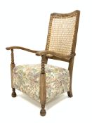 Victorian beech framed arm chair, cane back panel, seat upholstered in floral patterned fabric,