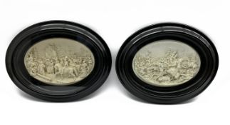 Pair of oval plaster relief plaques, one of a Religious procession, the other a battle scene,