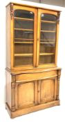 Victorian mahogany bookcase on cupboard, plain cornice over floral carved applied corbels,