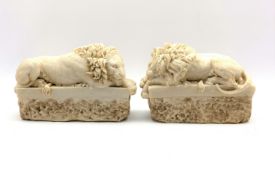 Pair of composition figures of sleeping lions,