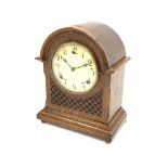 Early 20th century American oak cased mantel clock, arched hood, blind fret work detail,