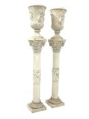 Pair 20th century reconstituted marble urns on pedestals of classical design,