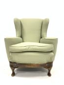 Georgian design stained beech framed upholstered wingback arm chair, with out swept arms,