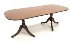 Regency design mahogany twin pedestal dining table, cross banded top with boxwood string inlay,