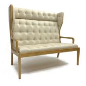 Contemporary light oak framed two seat wing back hall settee, upholstered in quilted beige leather,