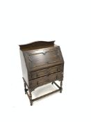 Early 20th century Jacobean design oak bureau, raised moulded top,