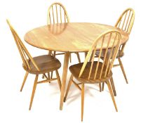 Ercol elm and beach drop leaf table, oval moulded top raised on turned splayed supports,