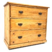 19th century varnished pine chest with three long graduating drawers, skirted base, brass castors,